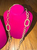 Necklace draped on display bust showing textured oval links