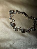 Bracelet in oval layout showing rhinestone flowers and leaf links