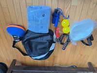 All items laid out: backpack, foam mat, jump rope, push-up bars, yellow balls, slider discs