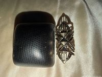 Ring beside presentation box showing overall length and pattern