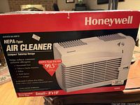 Front of Honeywell Enviracaire air cleaner retail box showing product image and specs