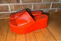 Side view of both orange platform sandals