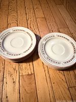 Top view of stacked saucers showing decorative rim pattern