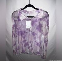 Front view of purple tie-dye collared blouse on hanger