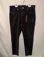 Full front view of jeans showing color, cut and attached tags