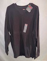 Full front view of black Craftsman waffle shirt on hanger showing length and sleeves