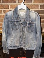Full front view of Calvin Klein denim jacket on hanger