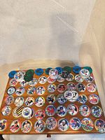 overhead view of assorted NHL pogs and plastic discs spread on table