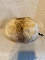 Front view of beige fur muff