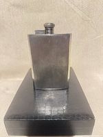 Front view of Birks silver-plated hip flask