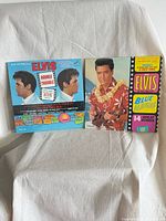 Both LP jackets side by side on fabric backdrop