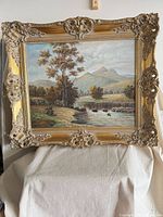 Front view of framed oil landscape painting