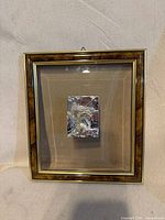 Frontal view of framed art showing full piece