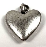 Front view of heart-shaped silver pendant with bail