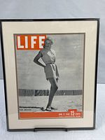 Full view of framed magazine cover with mat and frame