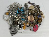 Full view of mixed jewelry pile showing variety of pieces