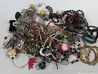 Full pile of mixed costume jewelry emptied from bag
