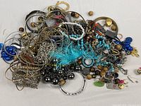 Pile of assorted costume jewelry from bag