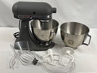 KitchenAid stand mixer with two bowls and attachments displayed