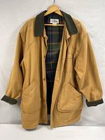 Full front view of tan L.L.Bean field coat showing corduroy collar and plaid lining