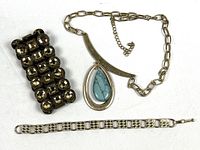 Overview of all three jewelry pieces: stud stretch cuff, pendant necklace, link bracelet