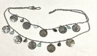 Full view of silver chain necklace showing hook clasp, two tiers, coin medallions, aqua and taupe beads