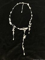 Full view of Swarovski crystal drip necklace against black background