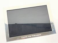 Front view of pewter frame showing engraving