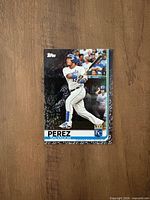 Front of card displaying player image, Topps logo, team logo, black border