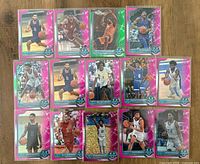 All fifteen pink refractor cards laid out in three rows on wood surface