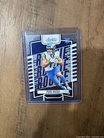 Front of 2023 Panini Absolute Puka Nacua rookie card in sleeve