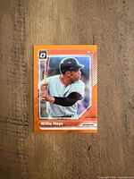 Front of Willie Mays Orange Refractor card with orange border and Optic logo