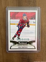 Front view of Cole Caufield rookie card in plastic top-loader