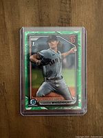 Front of 2024 Bowman 1st Carson Whisenhunt green lunar refractor card in top loader