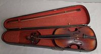 Violin in red-lined case with one bow