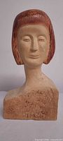 Front view of carved wooden female bust