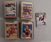 Stacks and single rookie cards including Rob Blake, New York Rangers player, Peter Forsberg and others, many in top loaders