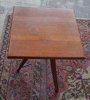 Top view of square wood surface with visible water ring and scratches