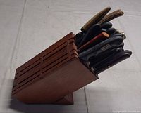 Side view of wooden knife block with knives inserted