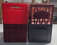 Front view of four stacked plastic crates showing colors and lattice design