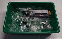 Bin containing assorted vintage laboratory glassware pieces