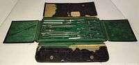 Open case showing all drafting instruments in green felt interior
