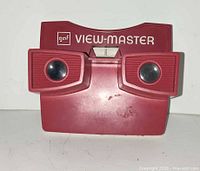 Front view of red GAF View-Master viewer showing logo, lenses and lever