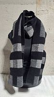 Scarf draped on mannequin showing overall size and check pattern