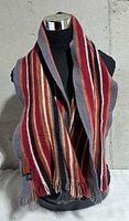 Scarf draped on mannequin, full length view shows stripe pattern and fringe