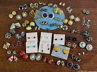 Group overview of all earring pairs laid out on table