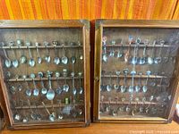 Both wood display cabinets side by side showing full spoon collection