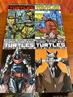 All four trade paperback volumes laid out together