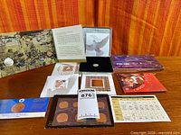 All commemorative coin and stamp items laid out