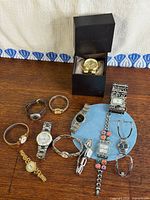 Group shot of all eleven watches including Michael Kors in box